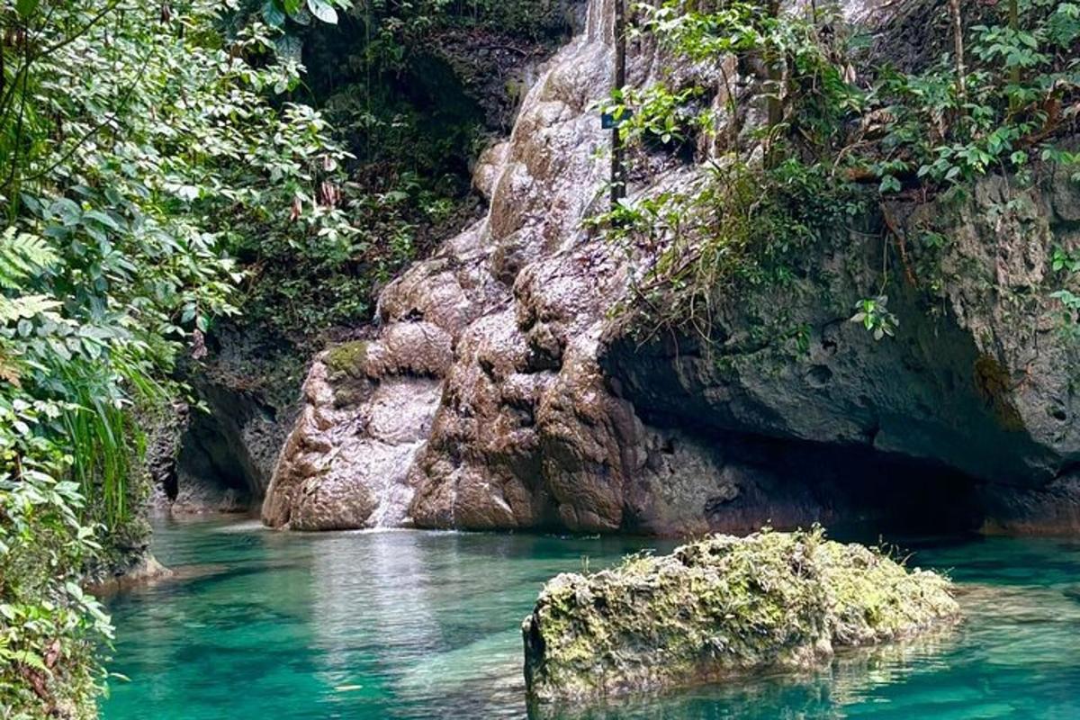 a pool of water in a river with rocks