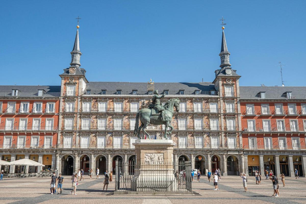a statue in front of a large building