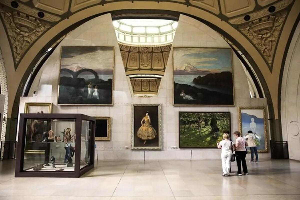 a museum with people looking at paintings on a wall