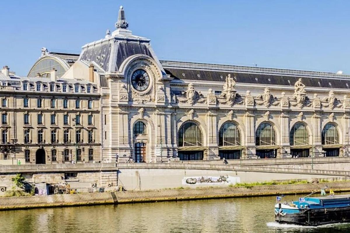 a large building next to a river with a boat