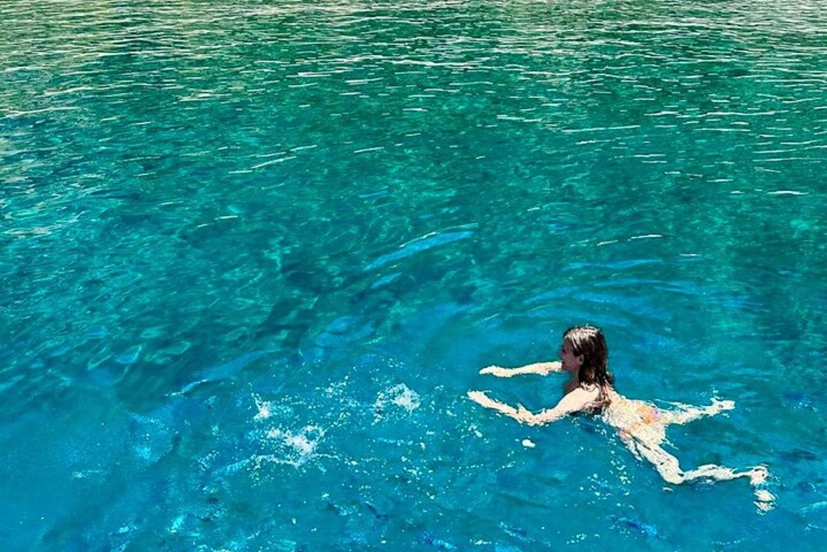 μια γυναίκα ξαπλωμένη στο νερό στον ωκεανό