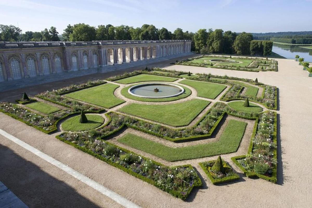 a garden with a clock in the middle of it