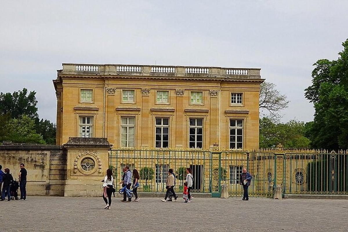 a group of people walking in front of a building