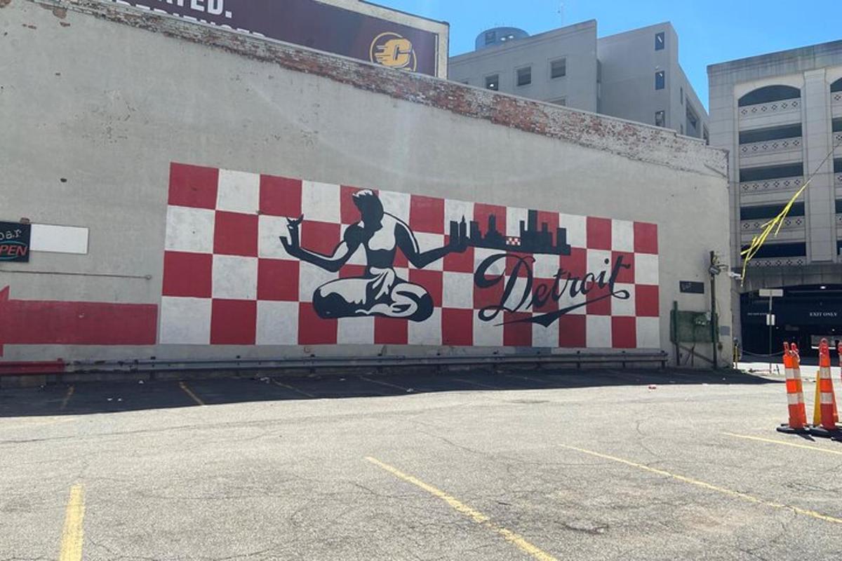 a wall with a mural of a man riding a motorcycle