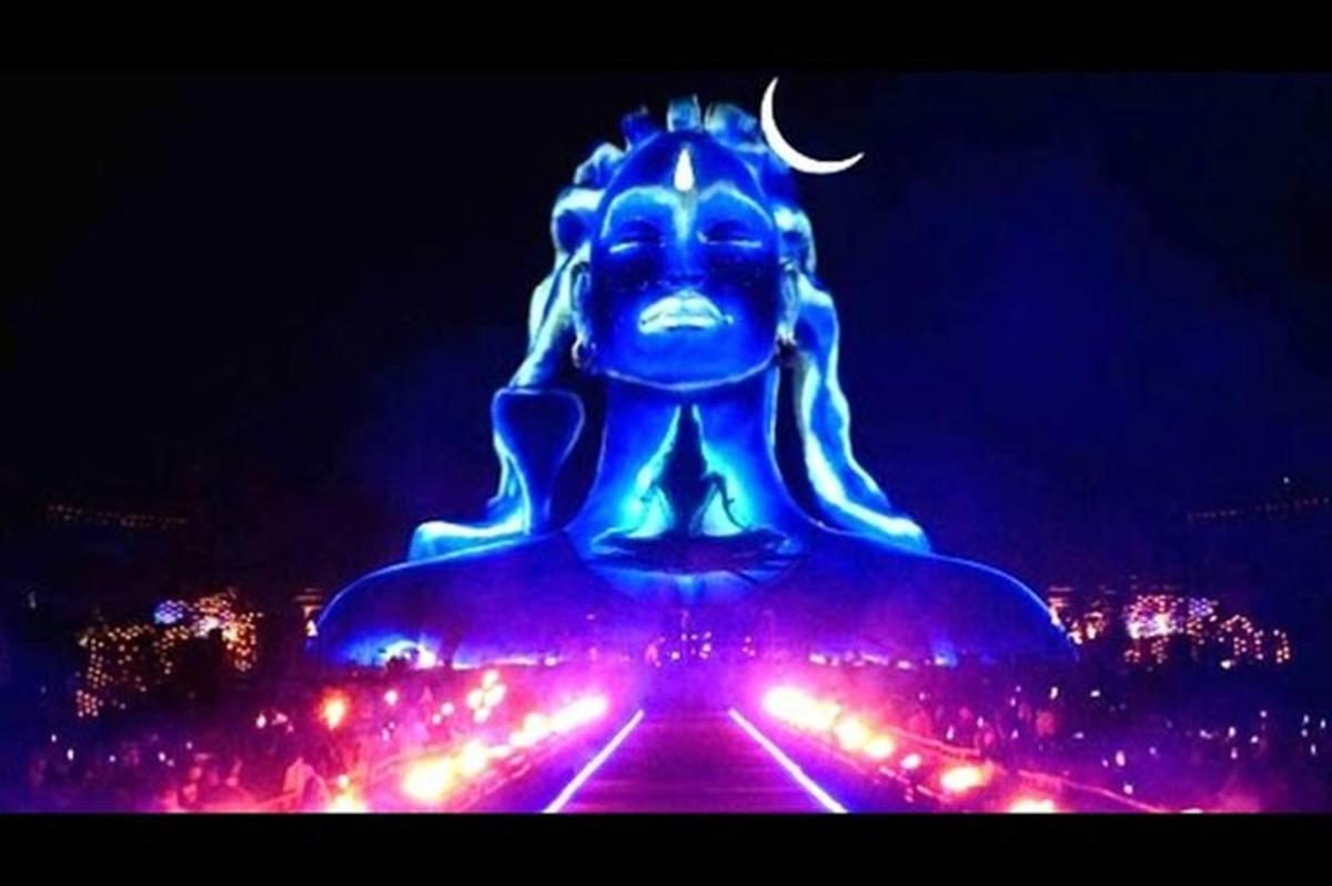 a lit up statue of a buddha with lights