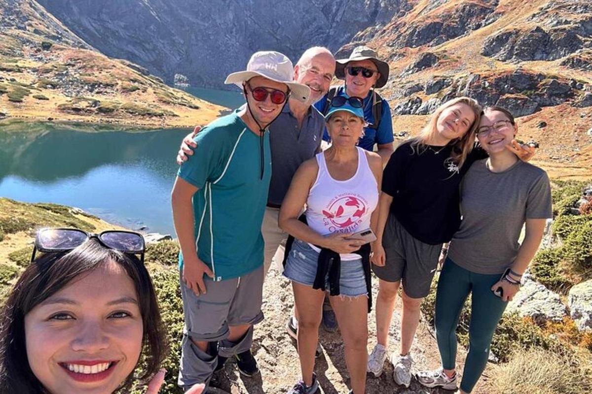 a group of people posing for a picture in front of a mountain