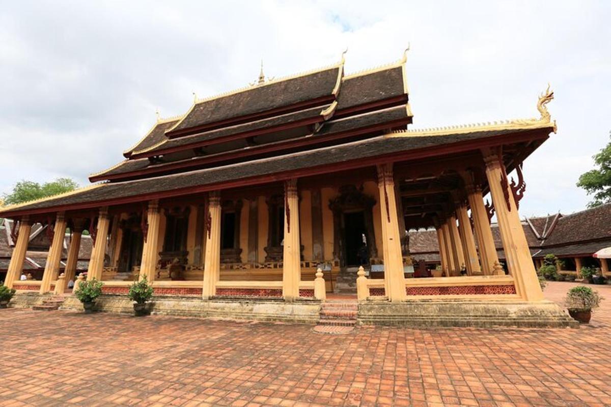a building with a roof on top of a brick ground
