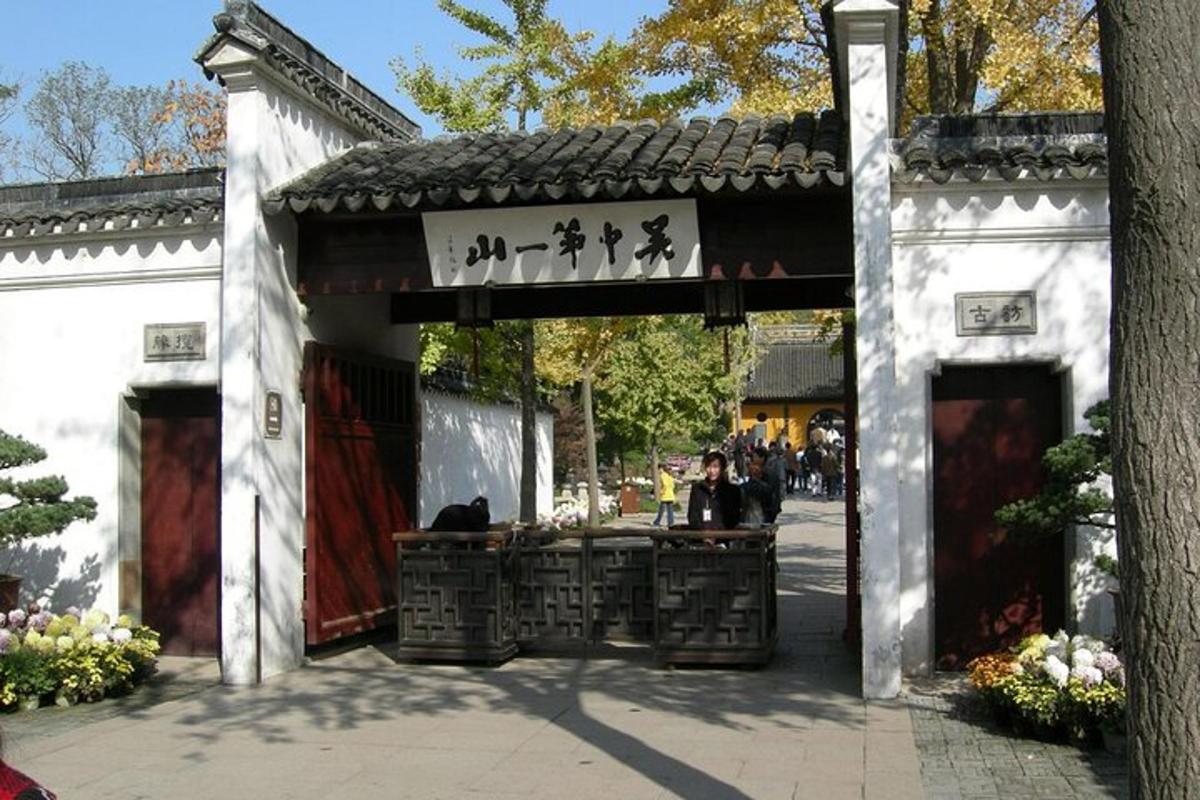 a building with a gate with people sitting in it