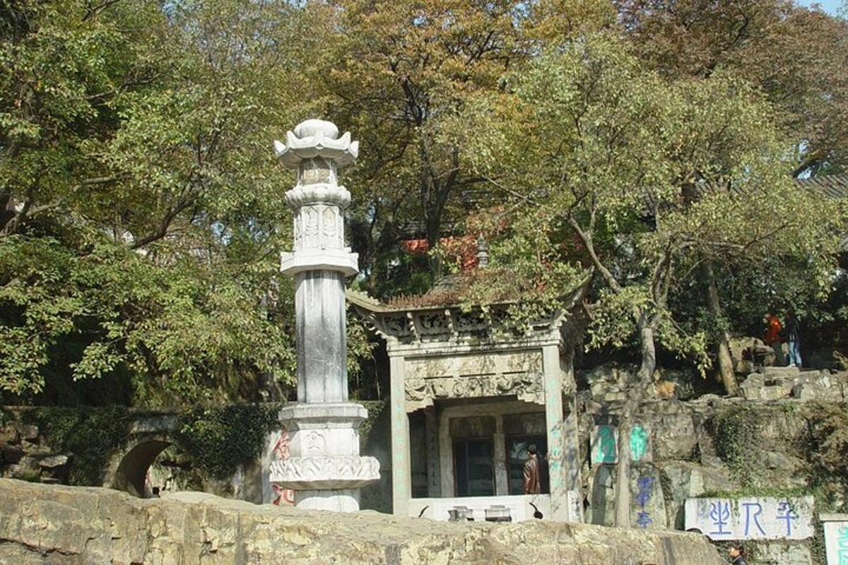 a monument in front of a building in a park