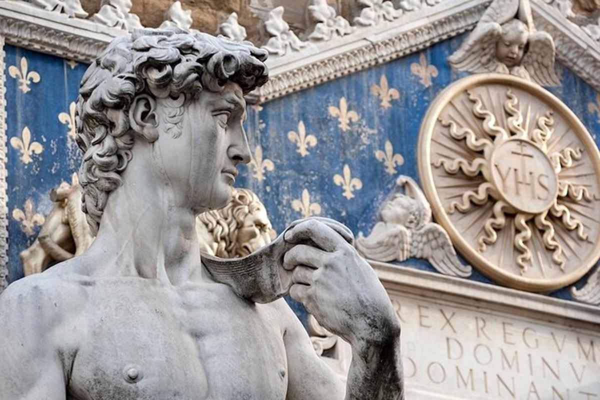 a statue of a woman holding a bowl in front of a building