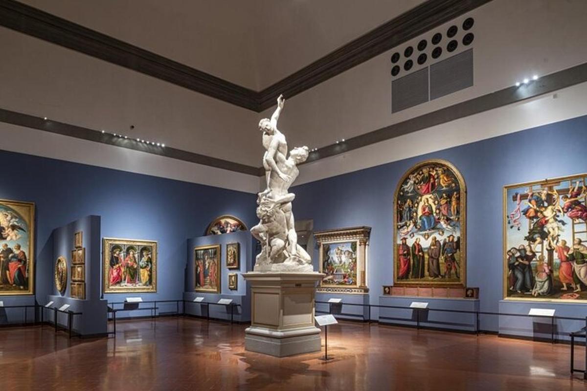 a museum with a statue in the middle of a room with paintings