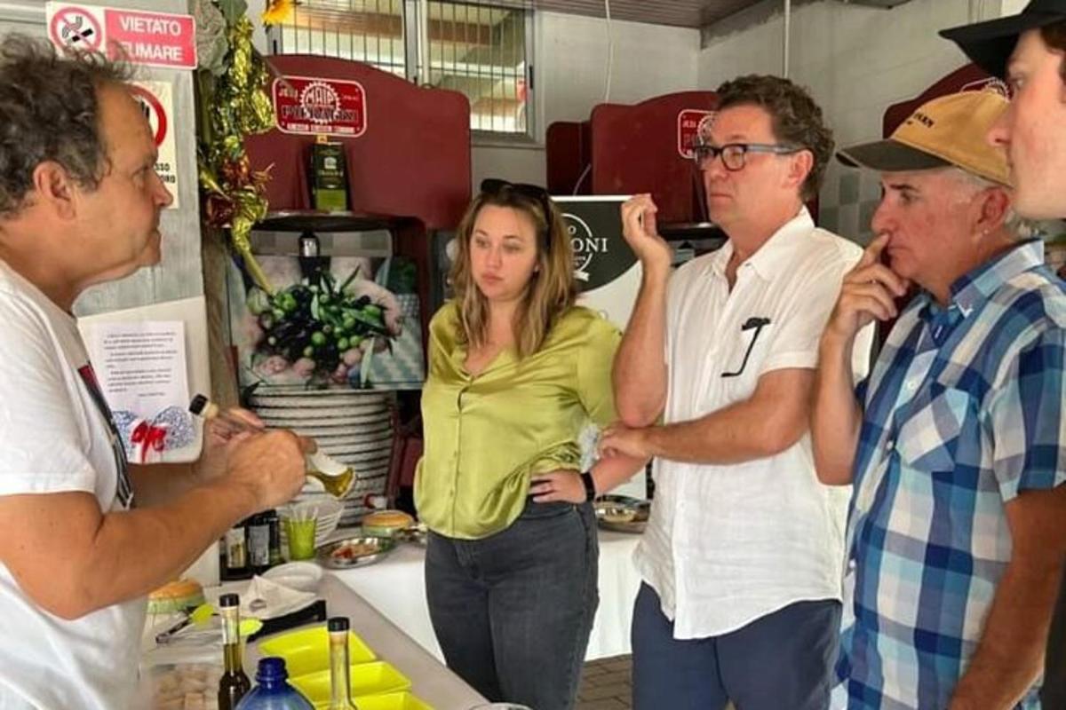 a group of people standing around in a kitchen