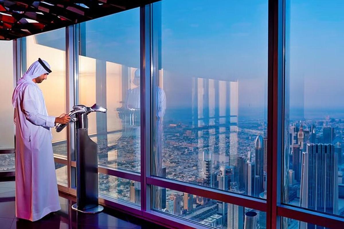 a man looking out the window of a skyscraper