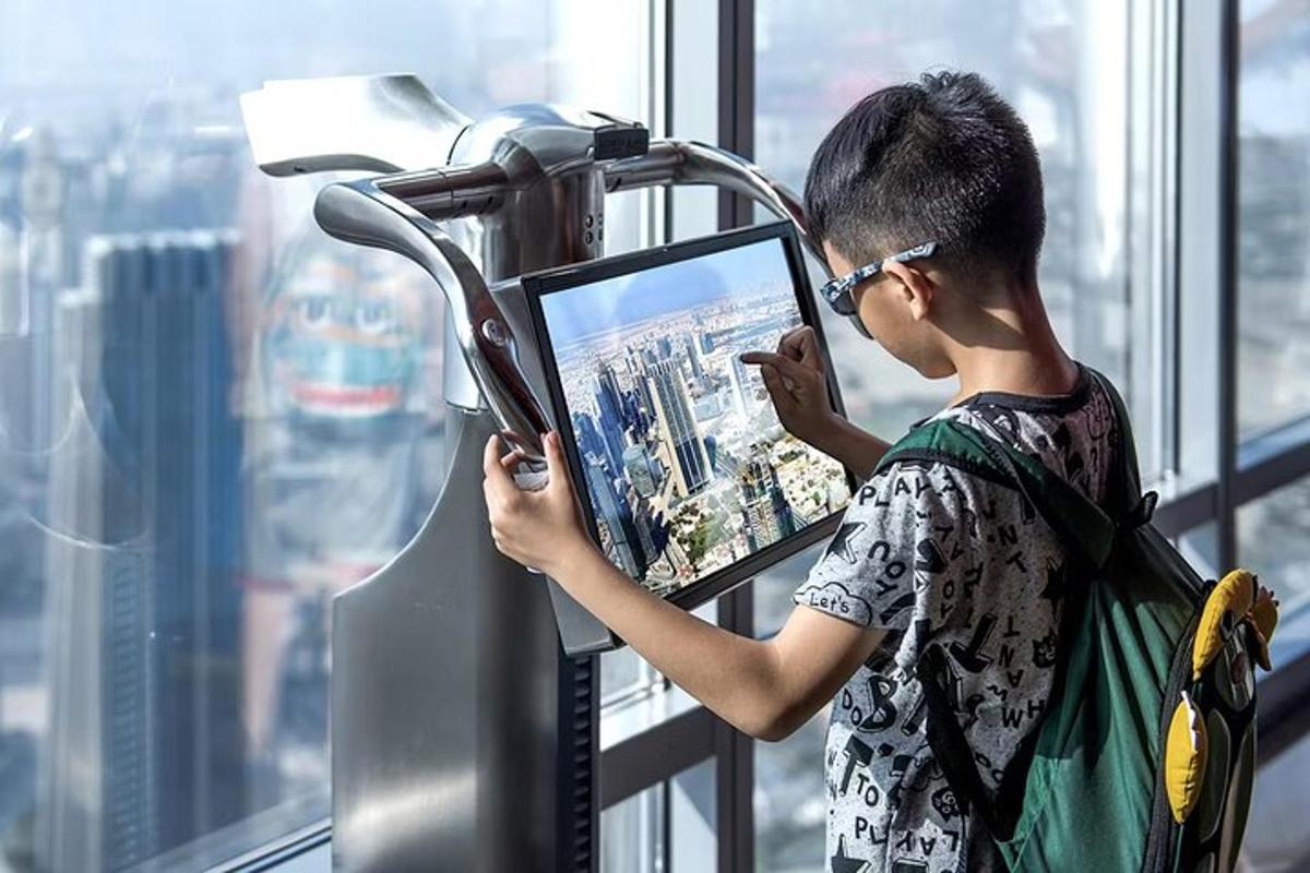 a young man in an elevator looking at his cell phone