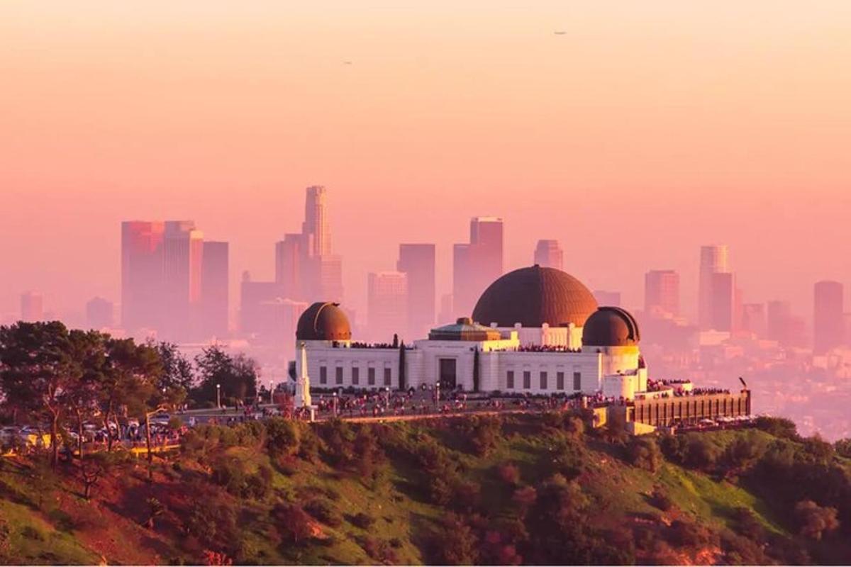 a building on a hill with a city in the background