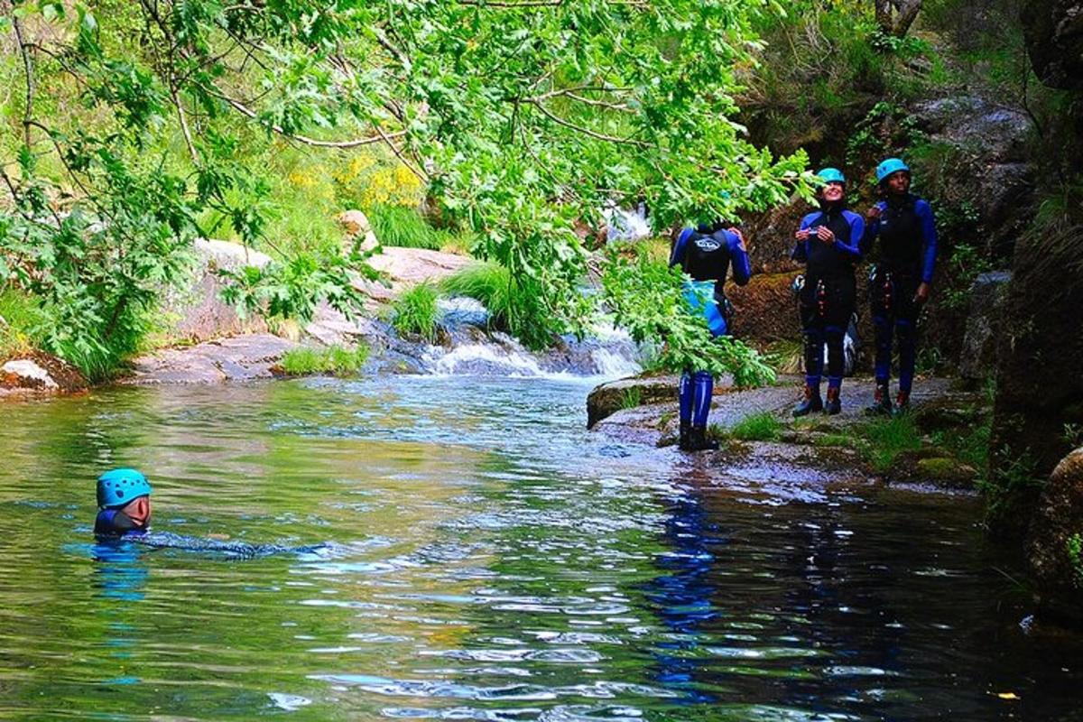 a group of people walking in a river