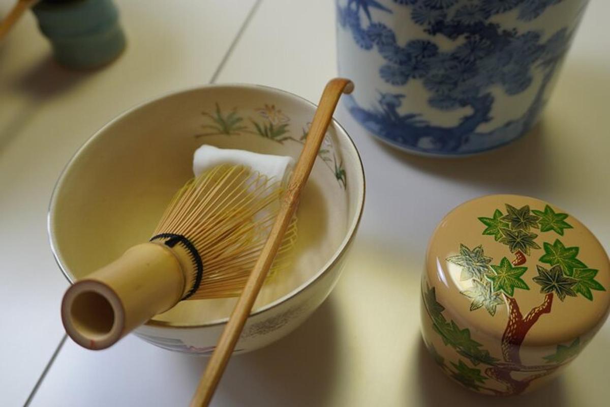 a bowl with a whisk and a broom on a table