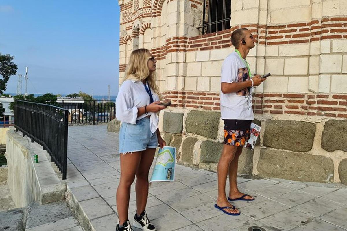 a man and a woman looking at their cell phones