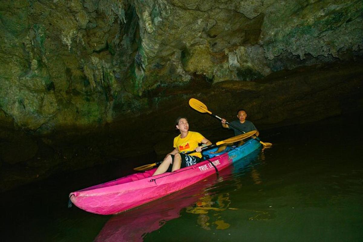 due persone in un kayak rosa in una grotta