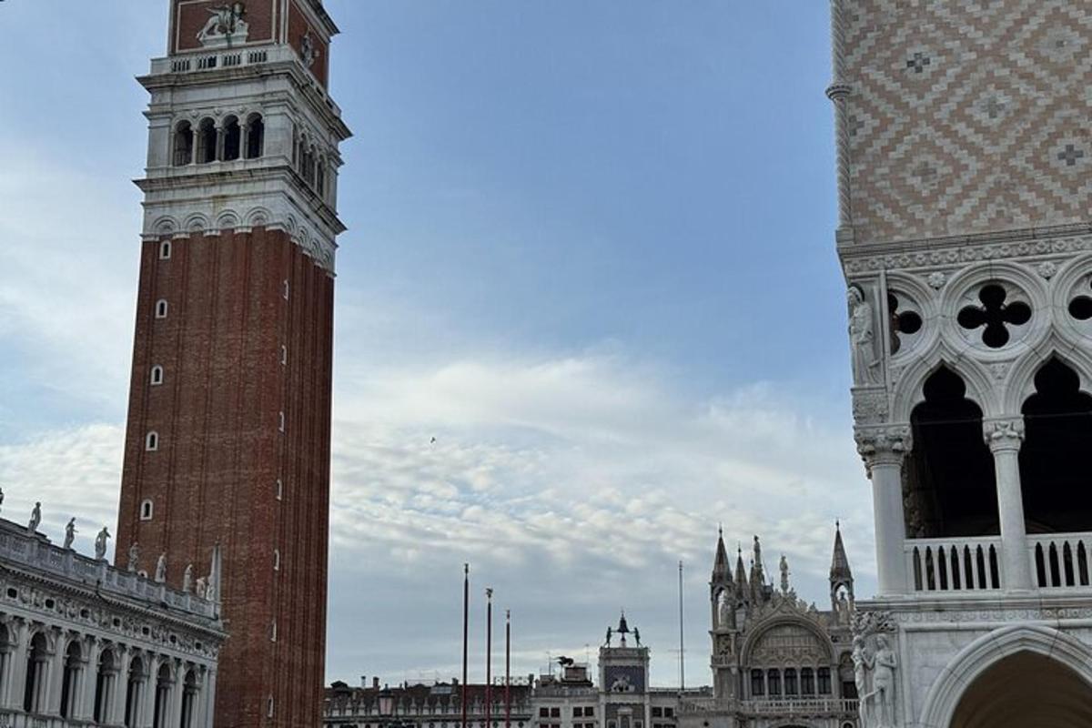 a tall clock tower in a city with a building