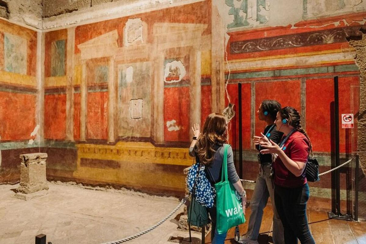 a group of people standing in front of a painting