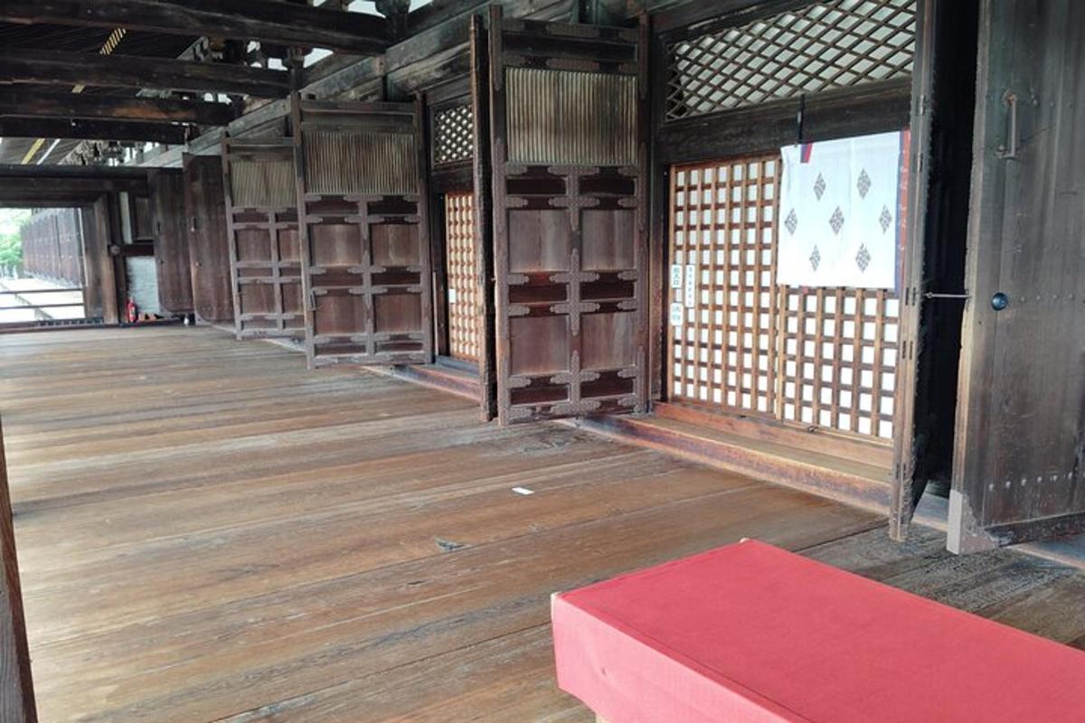 an empty room with wooden floors and a red table