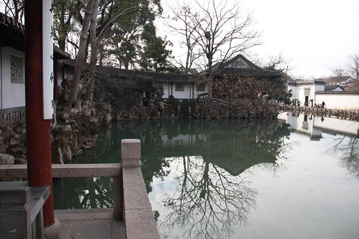 a reflection of a building in a body of water