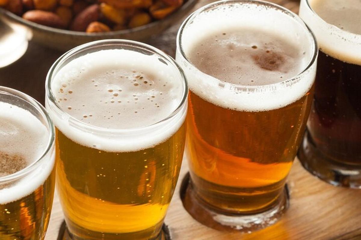 a group of four glasses of beer on a table