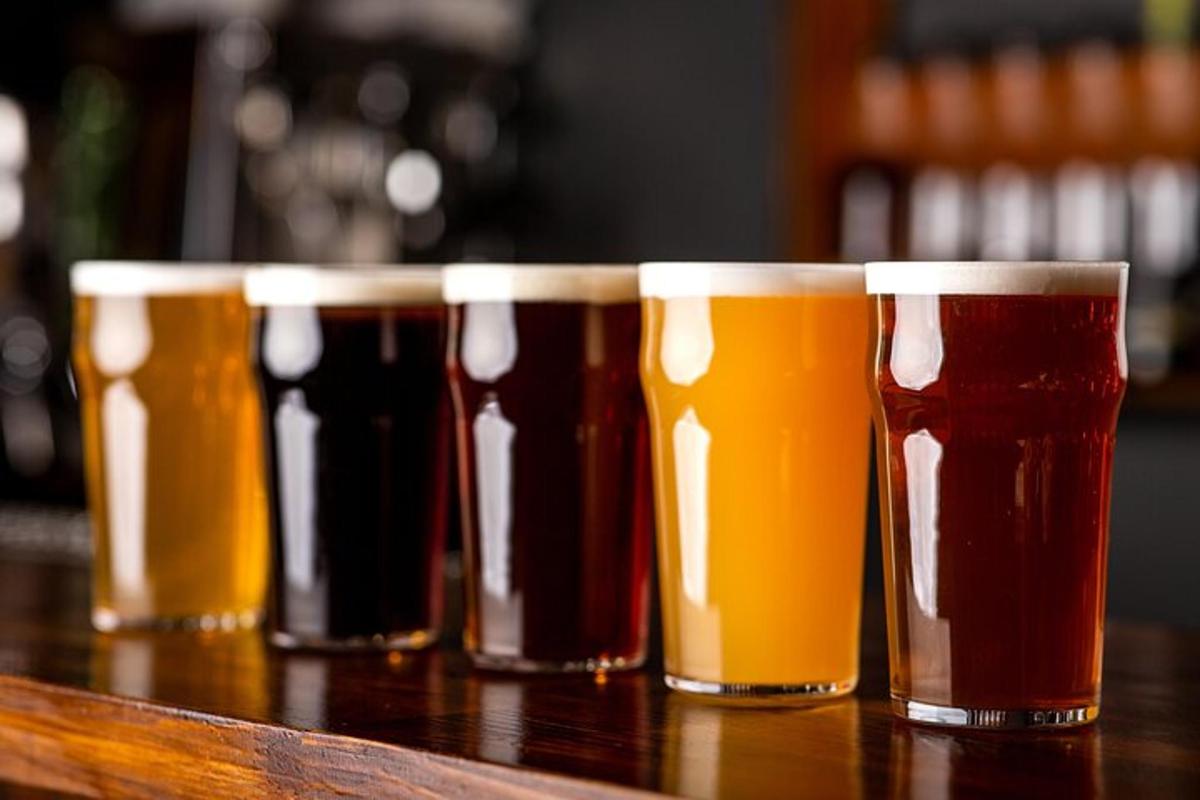 a row of different types ofints of beer on a table