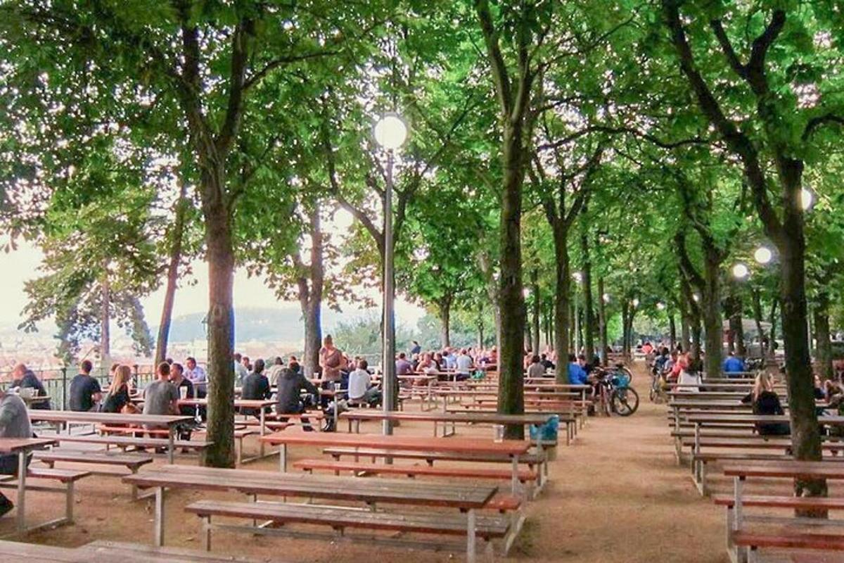 a group of people sitting on benches in a park