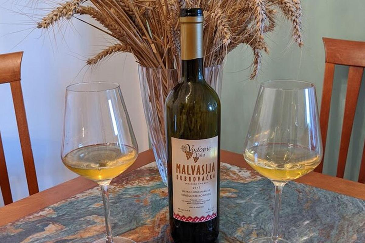 uma garrafa de vinho e duas taças de vinho sobre uma mesa