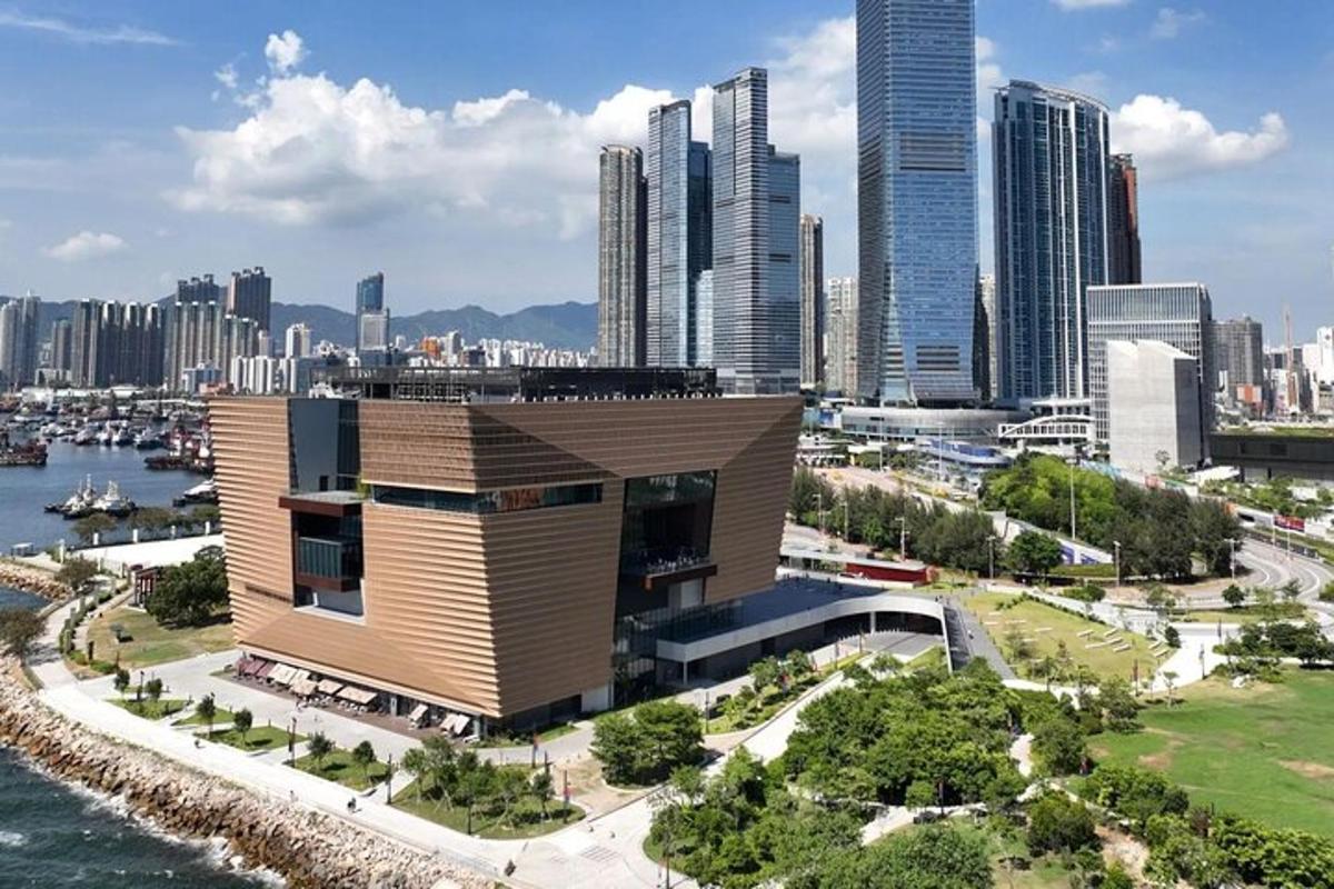a building in front of a city with tall buildings