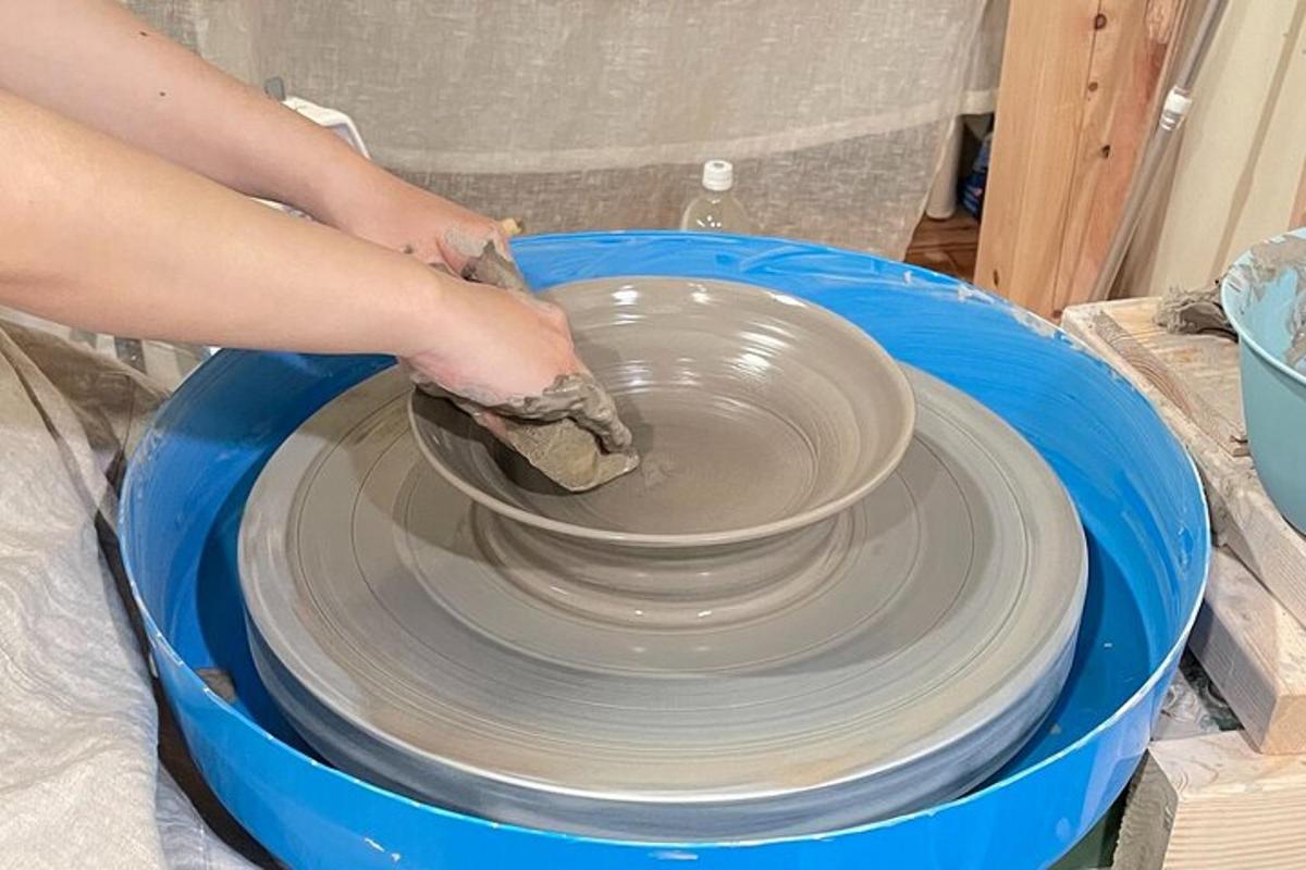 a person making a pot on a pottery wheel