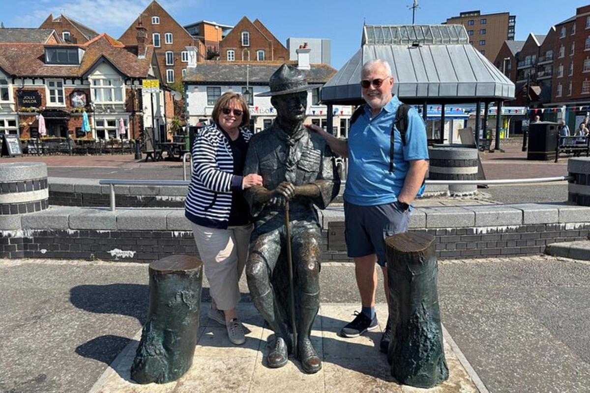 a man and a woman standing next to a statue
