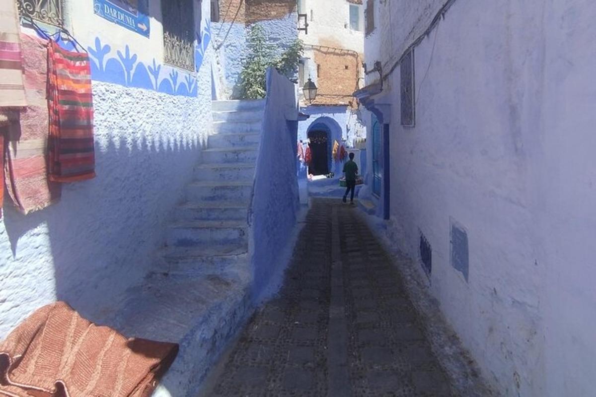 an alley with a person walking down a street