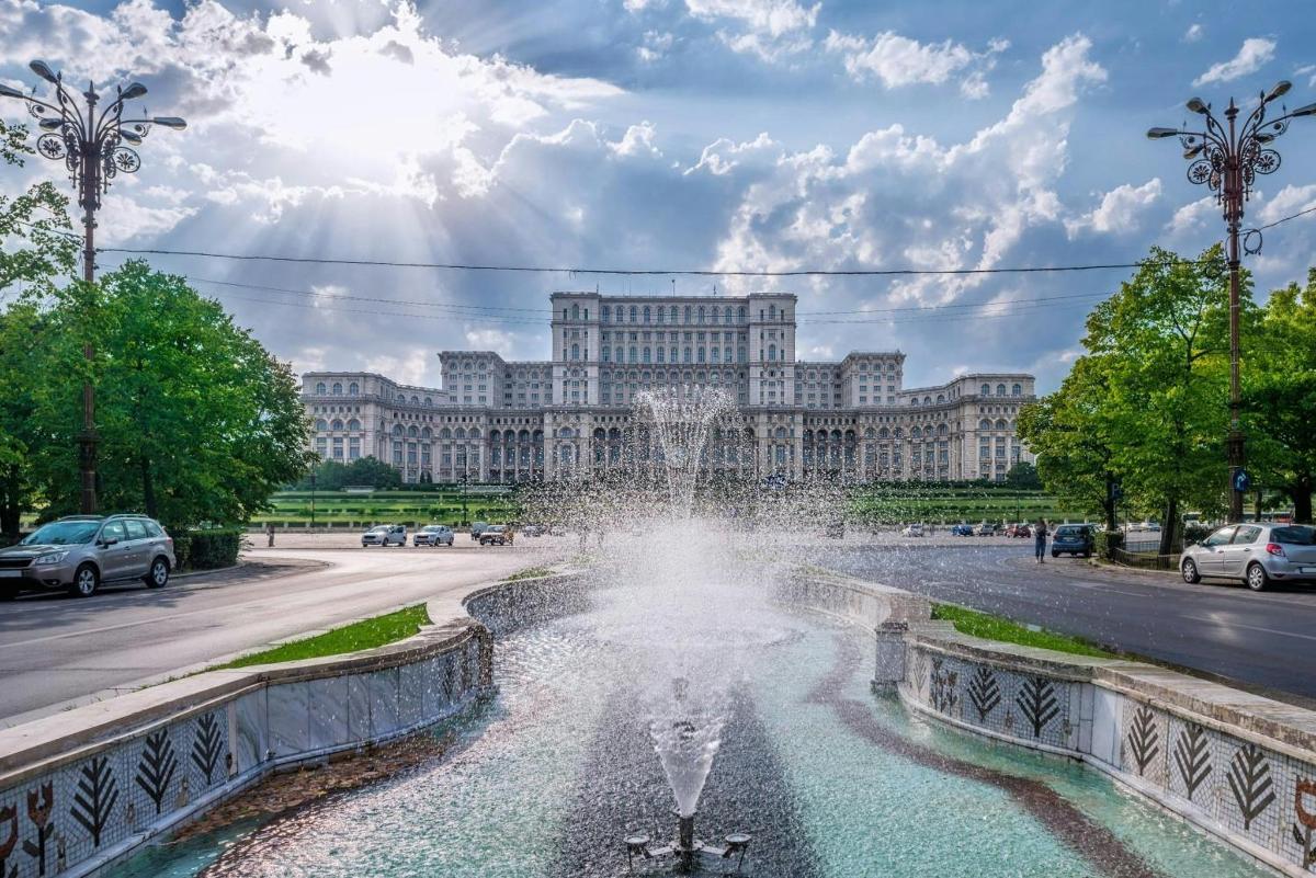 a fountain in front of a large building
