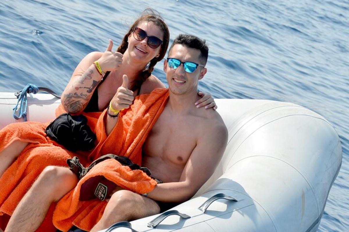 a man and a woman sitting on an inflatable raft in the water