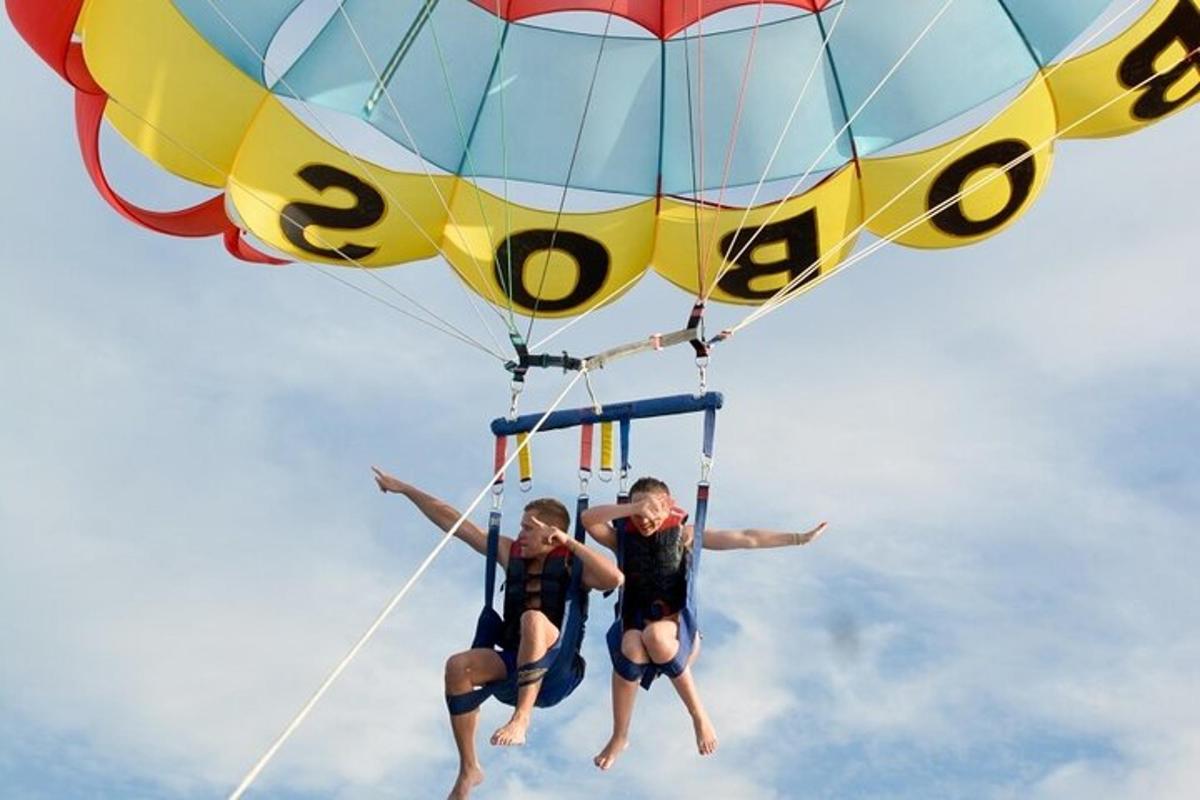 two people are hanging from a hot air balloon