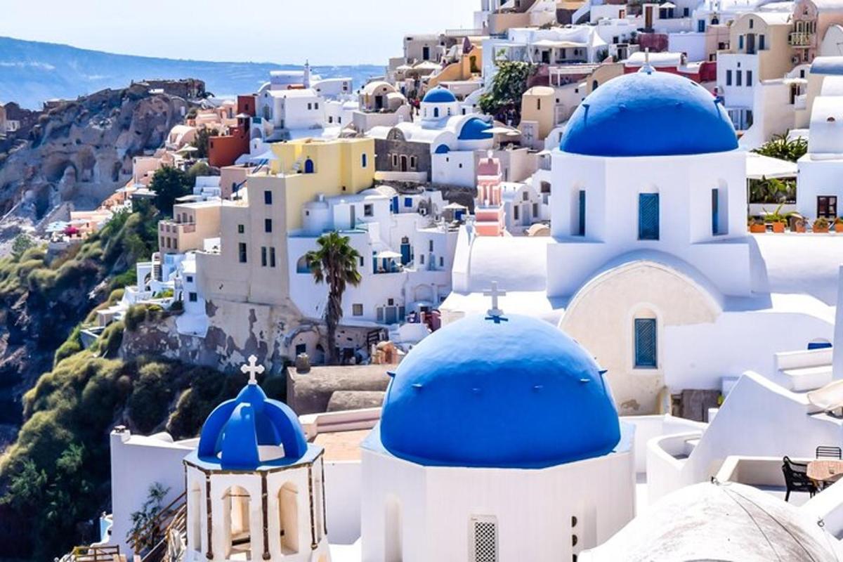 a view of a village with blue domes and buildings