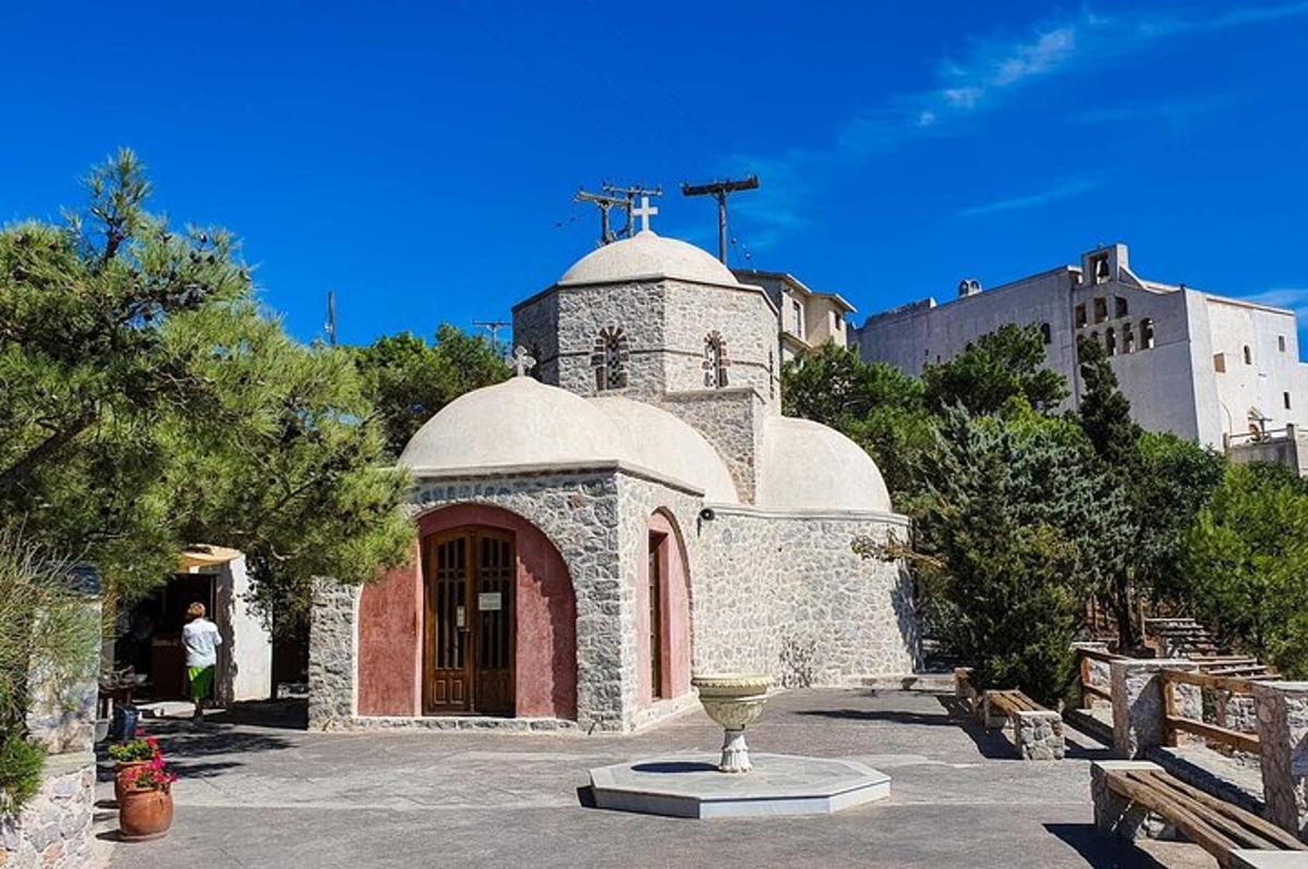 a small building with a cross on top of it