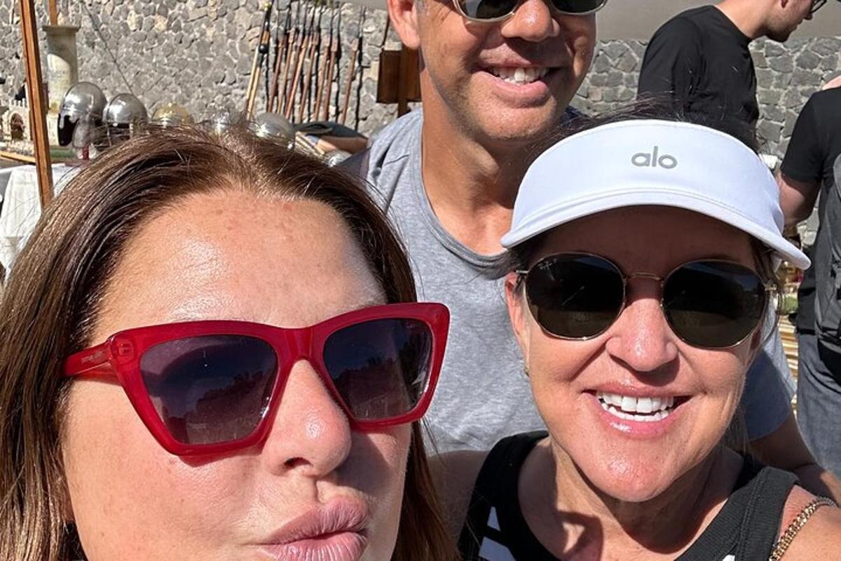 two people wearing red sunglasses and a man