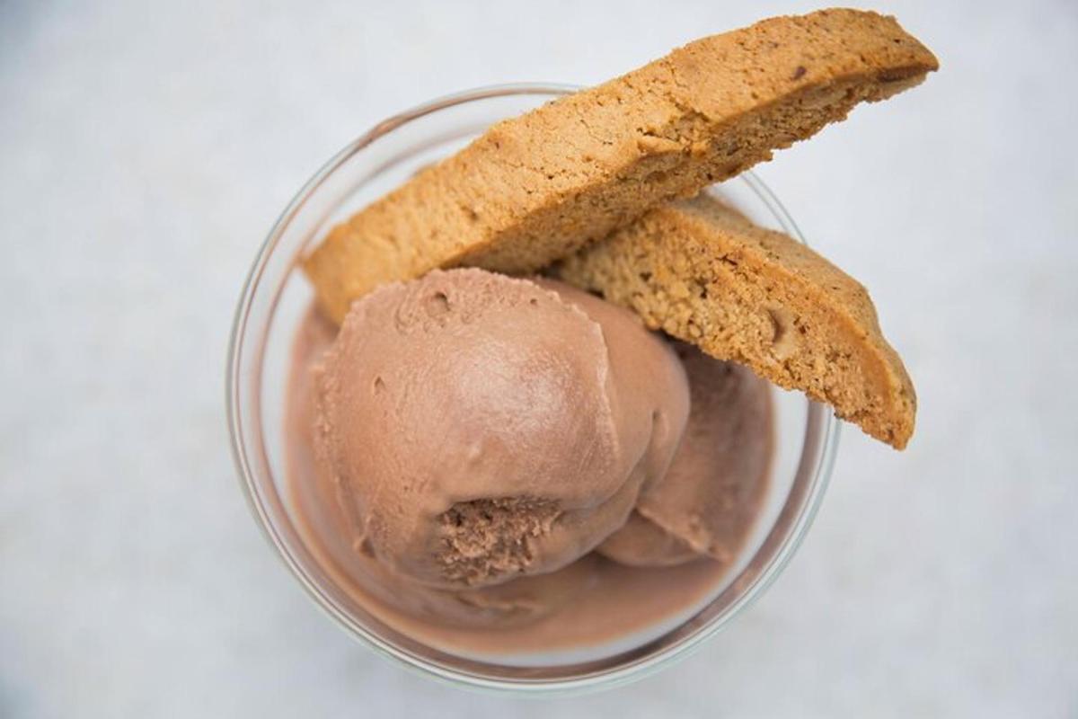 a bowl of chocolate ice cream and a piece of bread