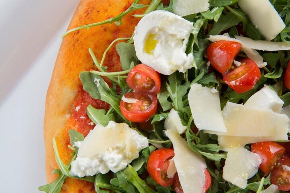 pizza paradicsommal és sajttal egy tányéron
