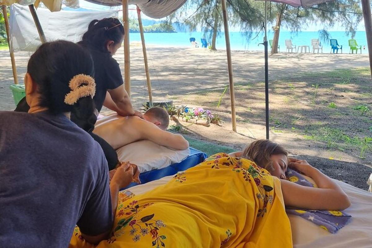un grup de persones estirades en llits a la platja
