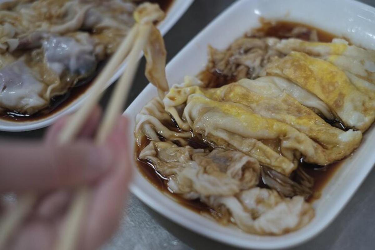 a plate of food with a bowl of food with chopsticks