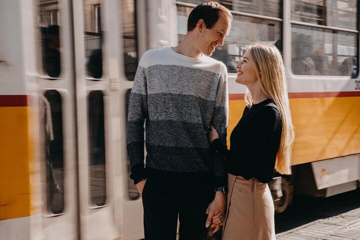 a man and a woman standing in front of a bus