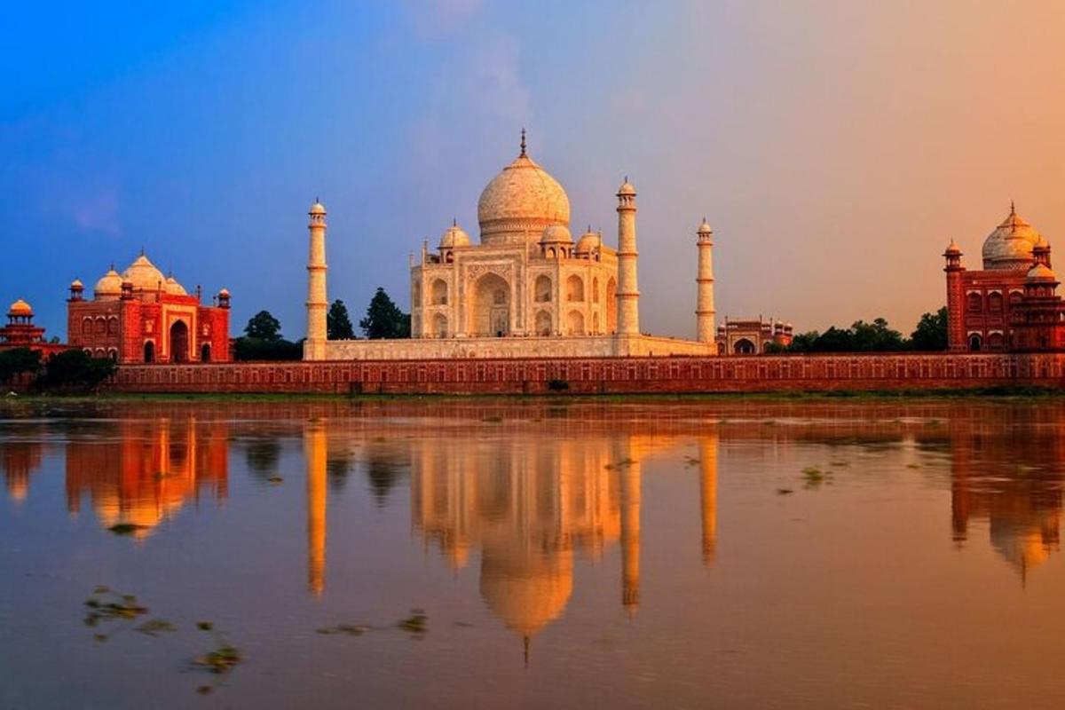 a view of the taj mahal with its reflection in the water