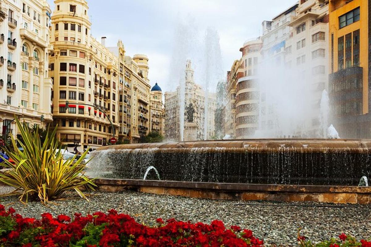a fountain in the middle of a city with buildings