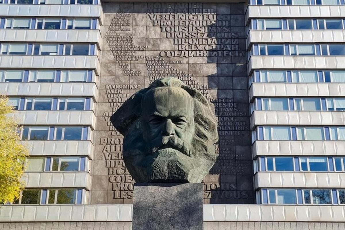 a statue of a head in front of a building