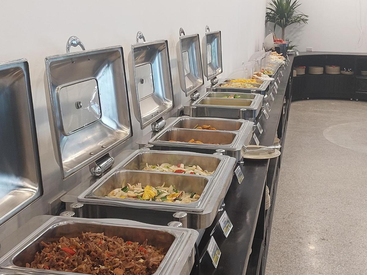 a row of trays of food in a buffet